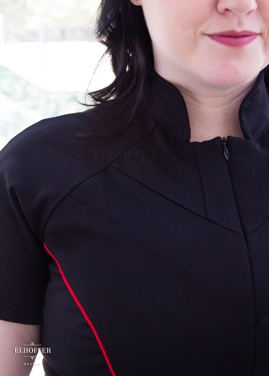 A close up of the seams and red piping detail.