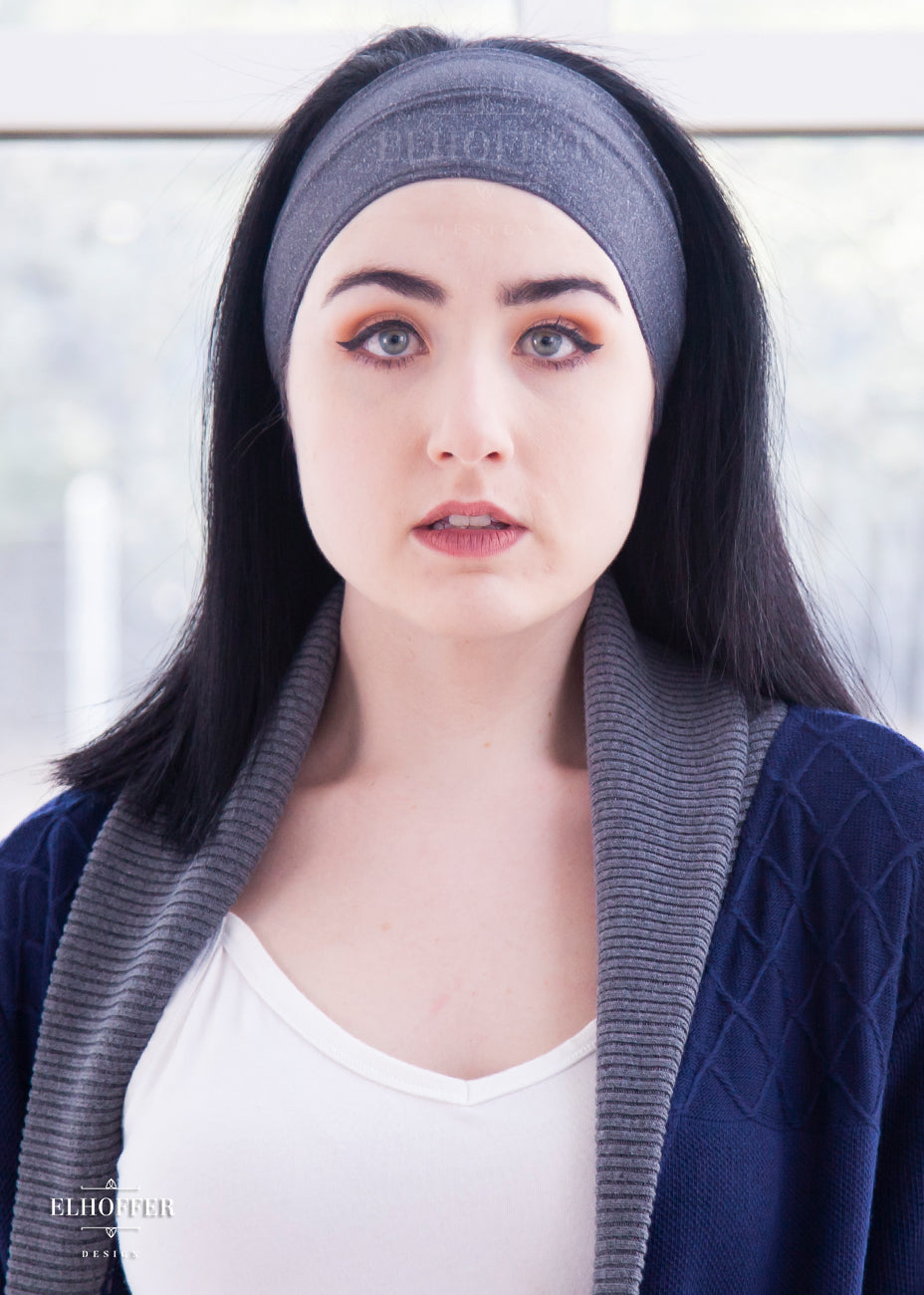 A heathered charcoal grey headband with hemmed edges. The headband is around 3" at the top and gradually gets smaller as it goes around the head.