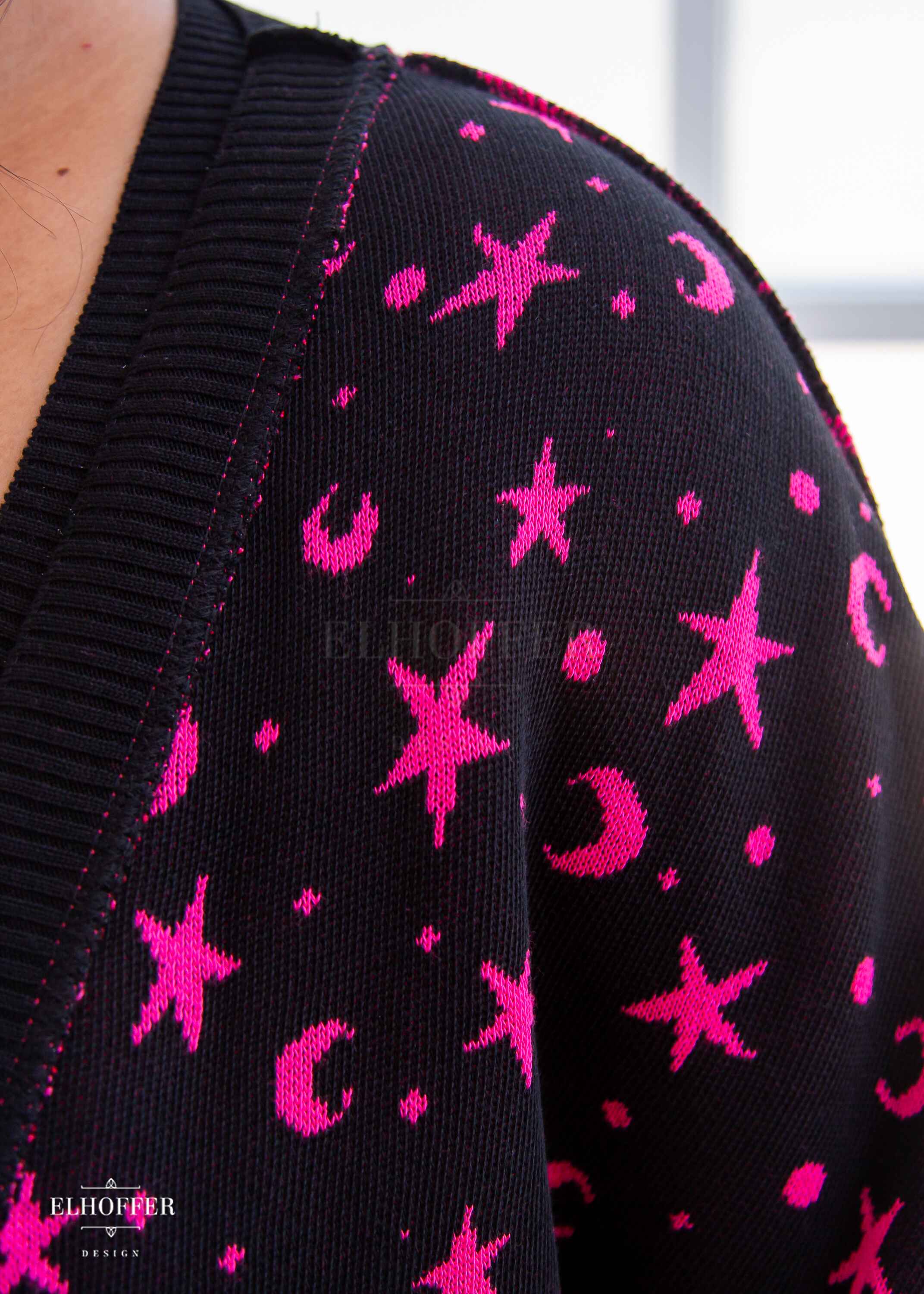 A closeup of the knit texture and star and moon pattern.