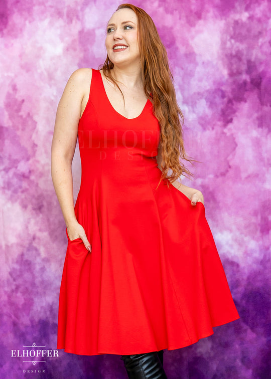 Woman wearing a red dress against a pink and purple gradient background with 'Elhoffer Design' branding.