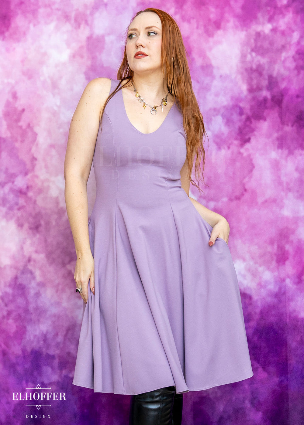 Woman wearing a purple dress against a pink and purple gradient background