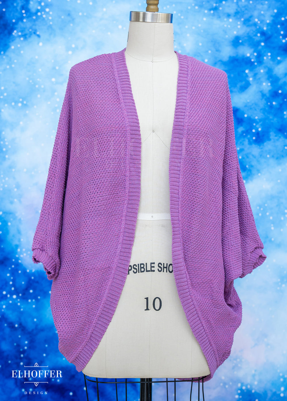 Purple cardigan on a mannequin against a blue snowy background