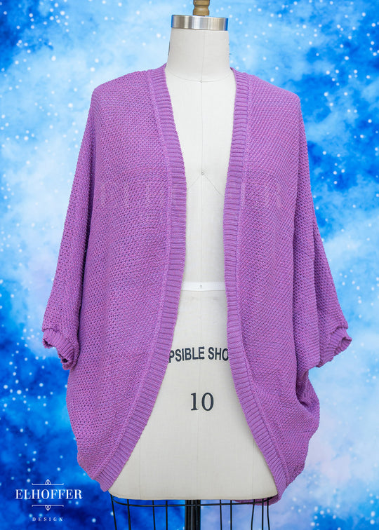 Purple cardigan on a mannequin against a blue snowy background