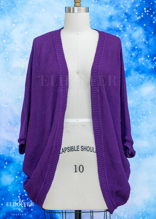 Purple cardigan on a mannequin against a blue snowy background