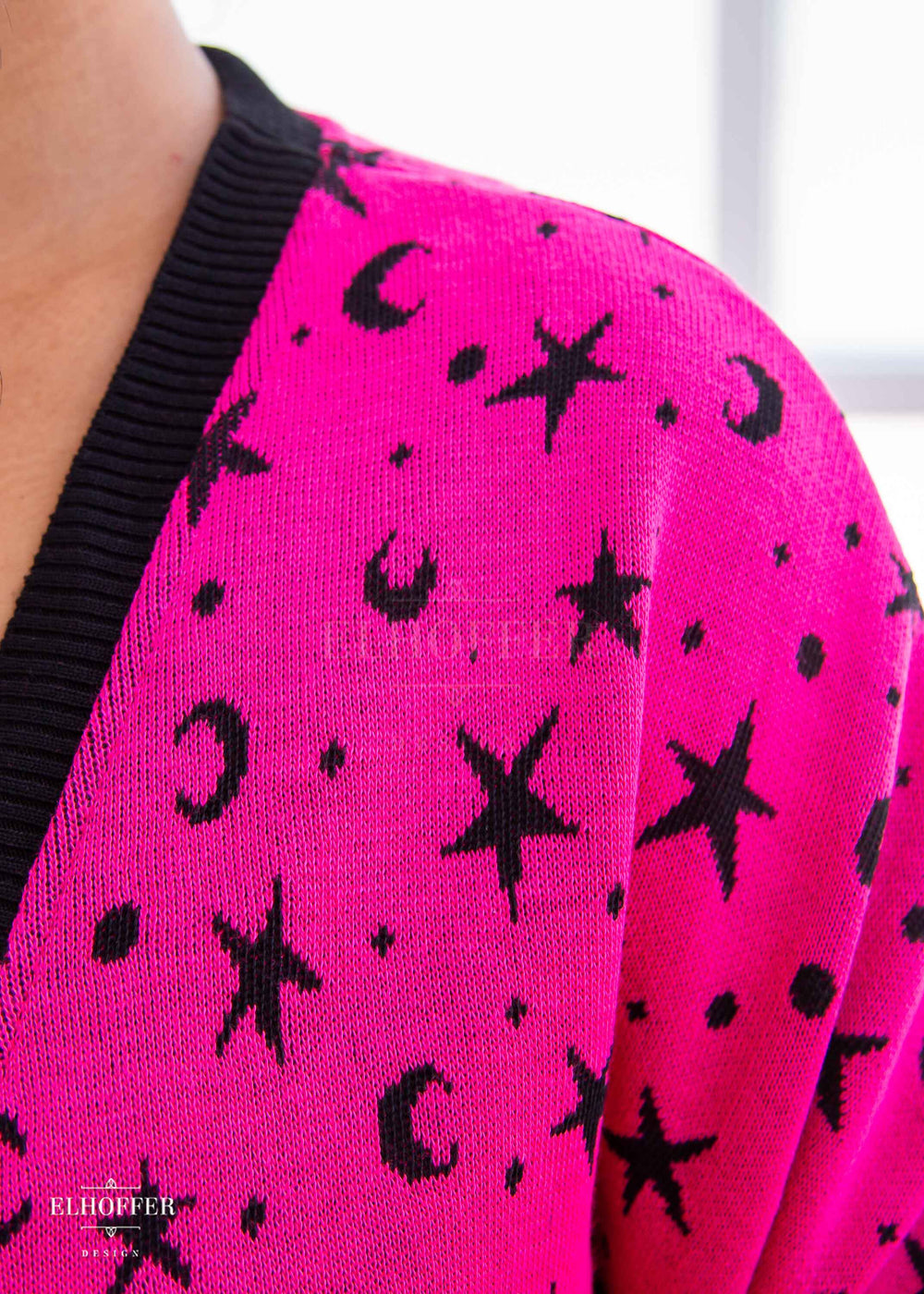 A closeup of the knit texture and star and moon pattern.