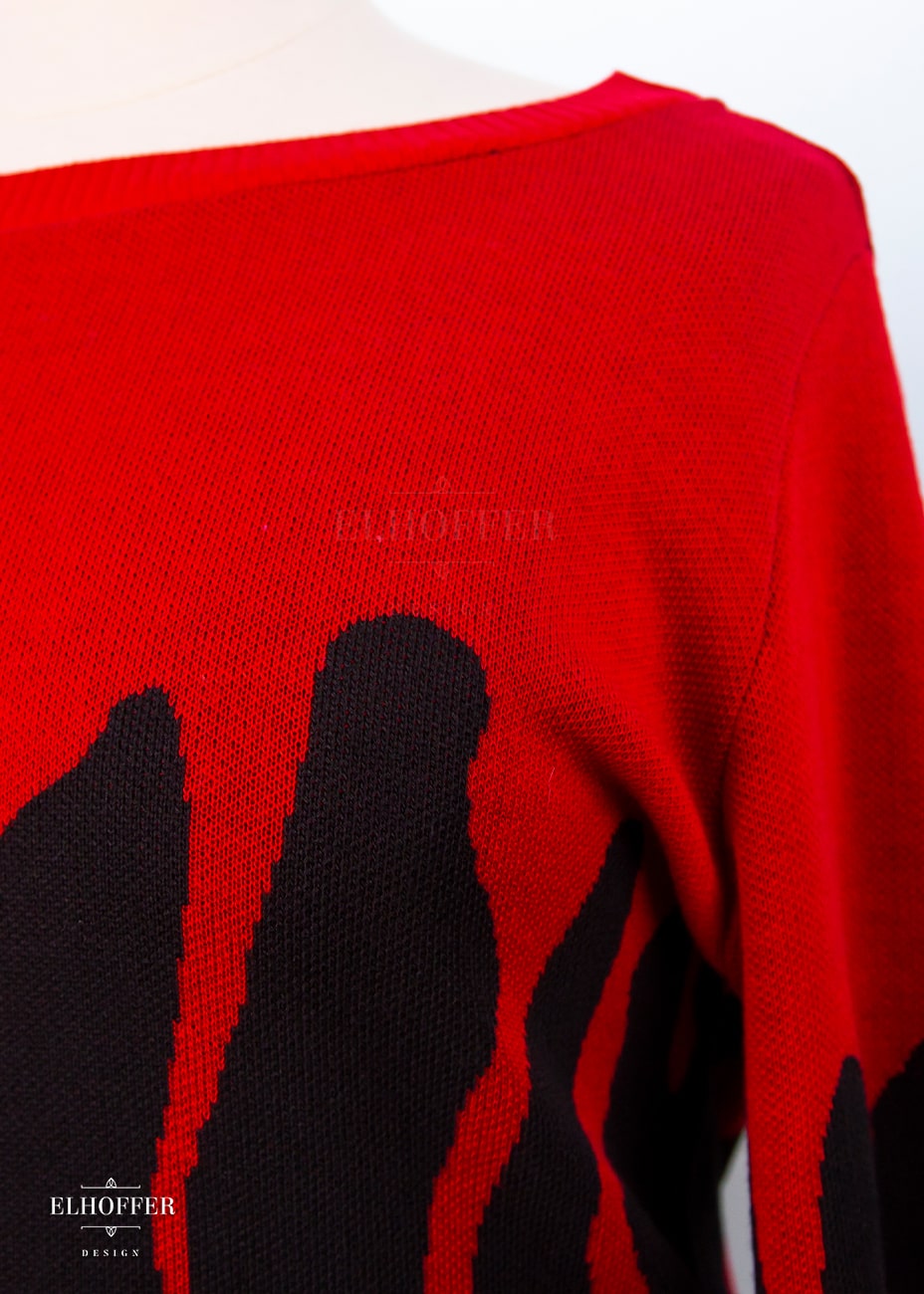 A close up of the blood drip design on the knit sweater