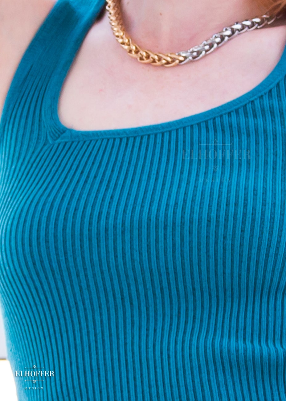 A close up of the rib knit and asymmetrical neckline.