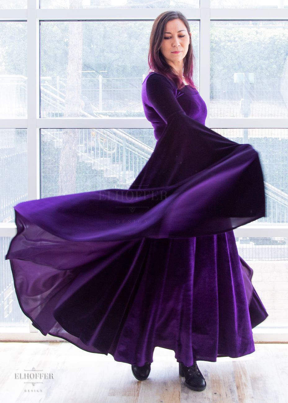 Susan twirls in the dress, the sleeves are fitted to the elbow and then fan out into long and full sleeves.