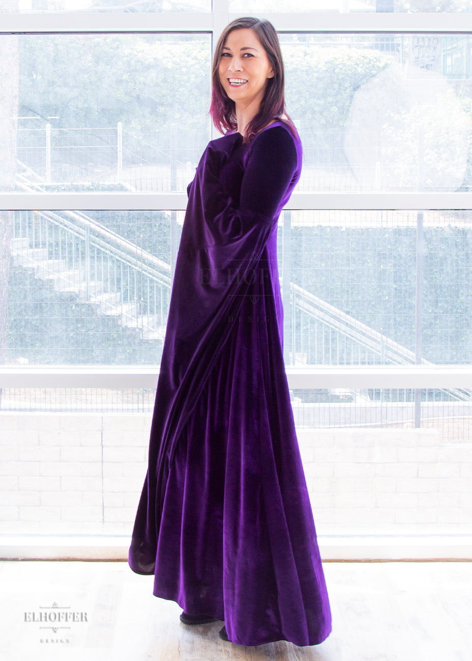 Susan wears the size extra small velvet gown. Her measurements are 32" Bust, 25" Waist, 36” Hips, and she is 5'9" tall.