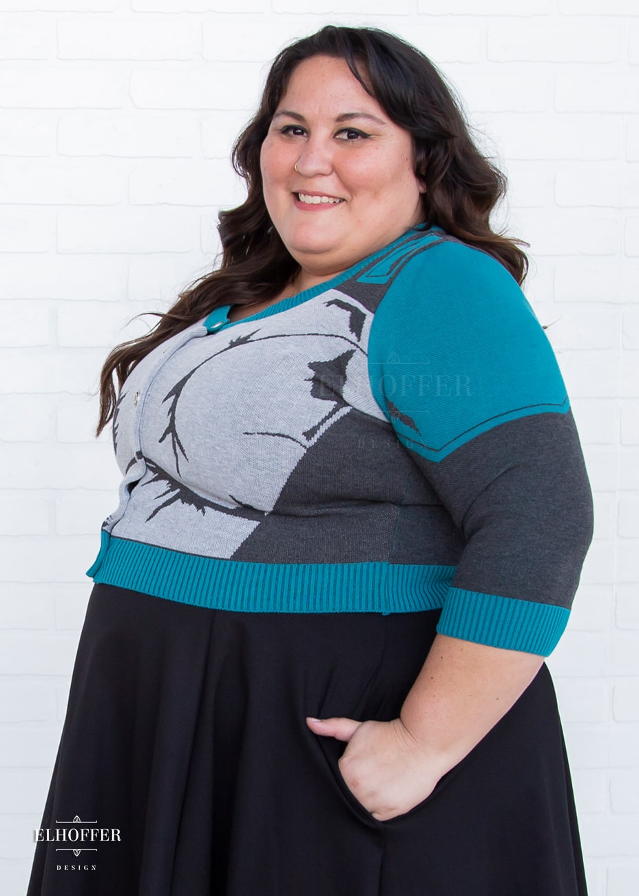 Alysia is modeling the Production 2XL. She has a 52” Chest, 46” Waist, 55” Hips, and is 5’4”.