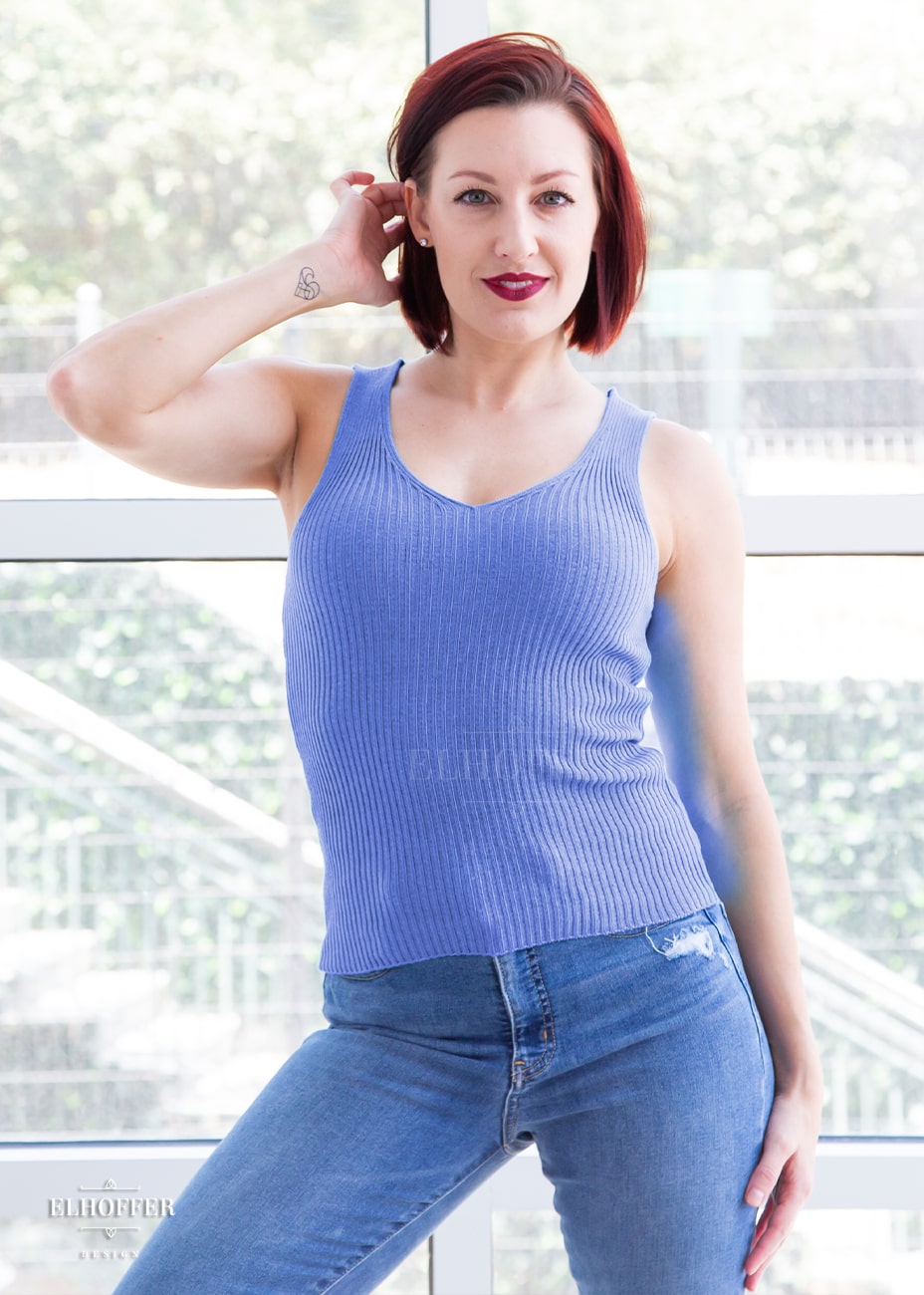 Natalie, a size small fair skinned model with short red hair, is wearing a pullover ribbed knit sleeveless tank in a periwinkle. 