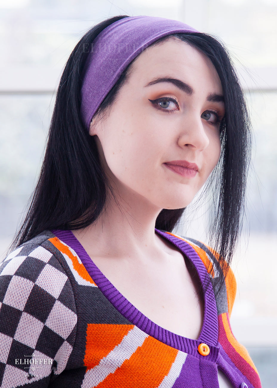 A heathered purple headband with hemmed edges. The headband is around 3" at the top and gradually gets smaller as it goes around the head.