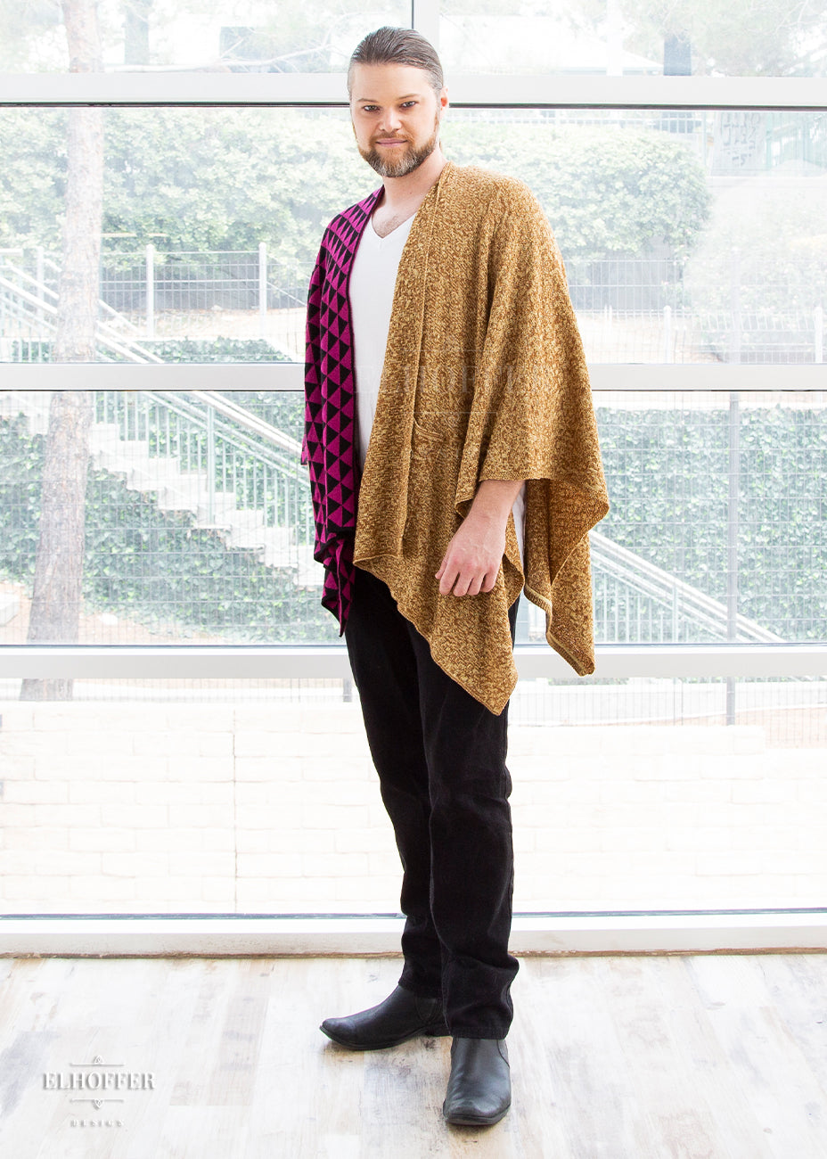 Bryan stands showing his left side, the golden colored half of the poncho.