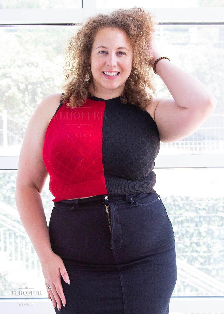 Anastasia, a curly haired, medium-skinned size XL model, is wearing our cropped Kwinn top. This harlequin diamond top features contrasting red and black fronts and backs trimmed in black accent rib and tape. 