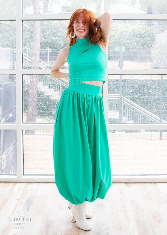 Chloe models the mock turtle neck sleeveless mint green crop top with matching harem style long pants with a fitted waistband and cuffs and flowy fabric.