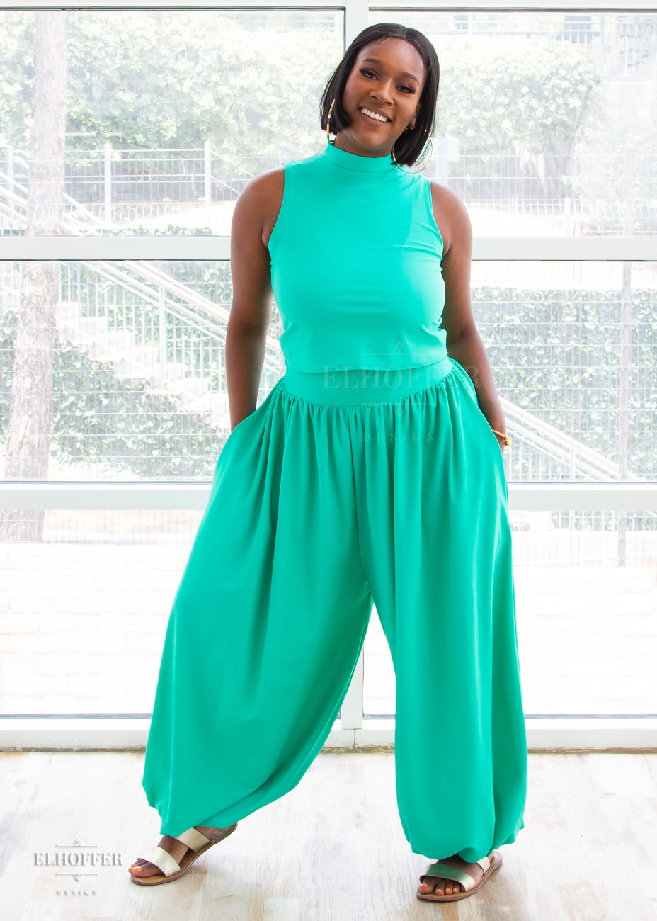 Lynsi models the mock turtle neck sleeveless mint green crop top with matching harem style long pants with a fitted waistband and cuffs and flowy fabric.