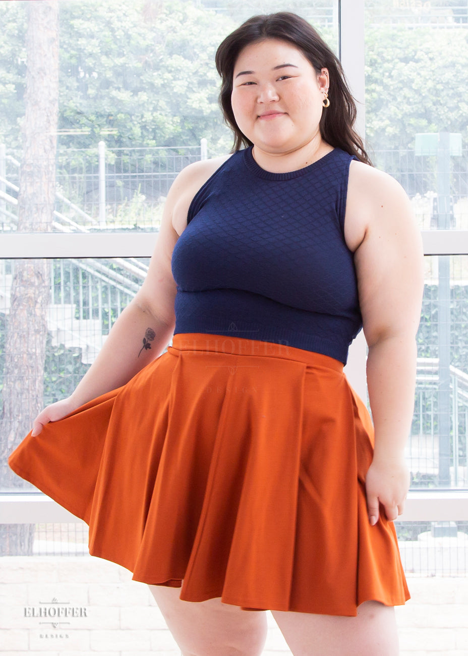 Ashley is modeling the size large skirt. She has a 44” Bust, 39” Waist, 52” Hips, and is 5’7”.