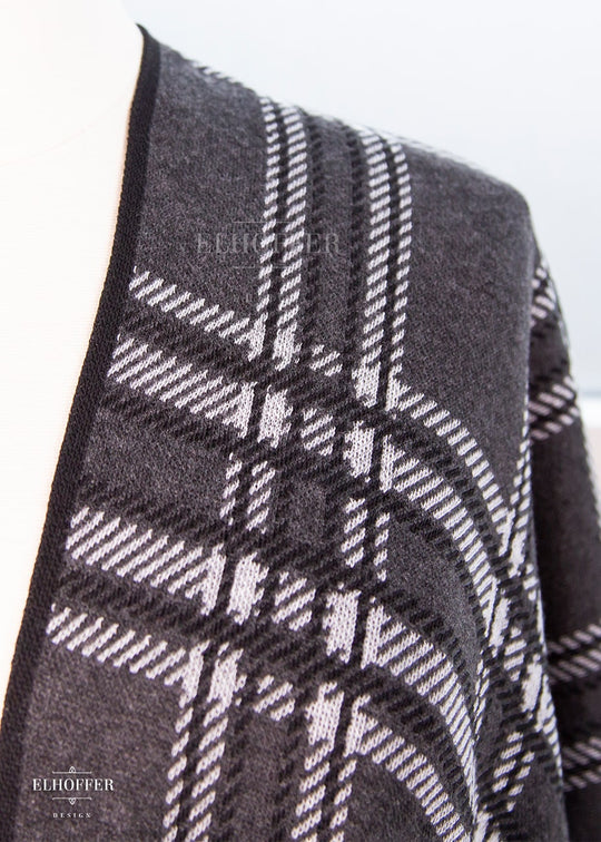 A close up of the knit texture and tartan pattern.