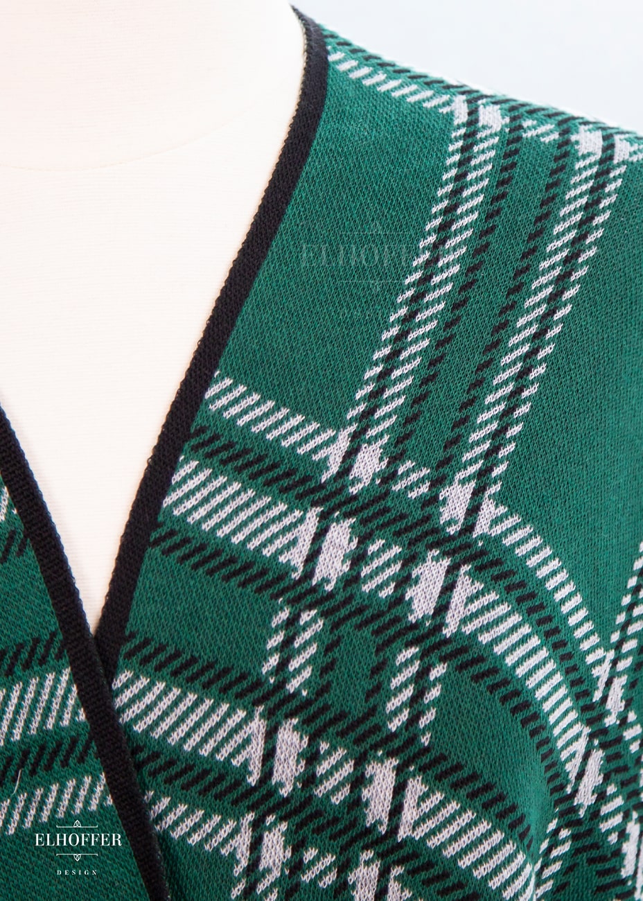 Close up of knit texture and tartan pattern.