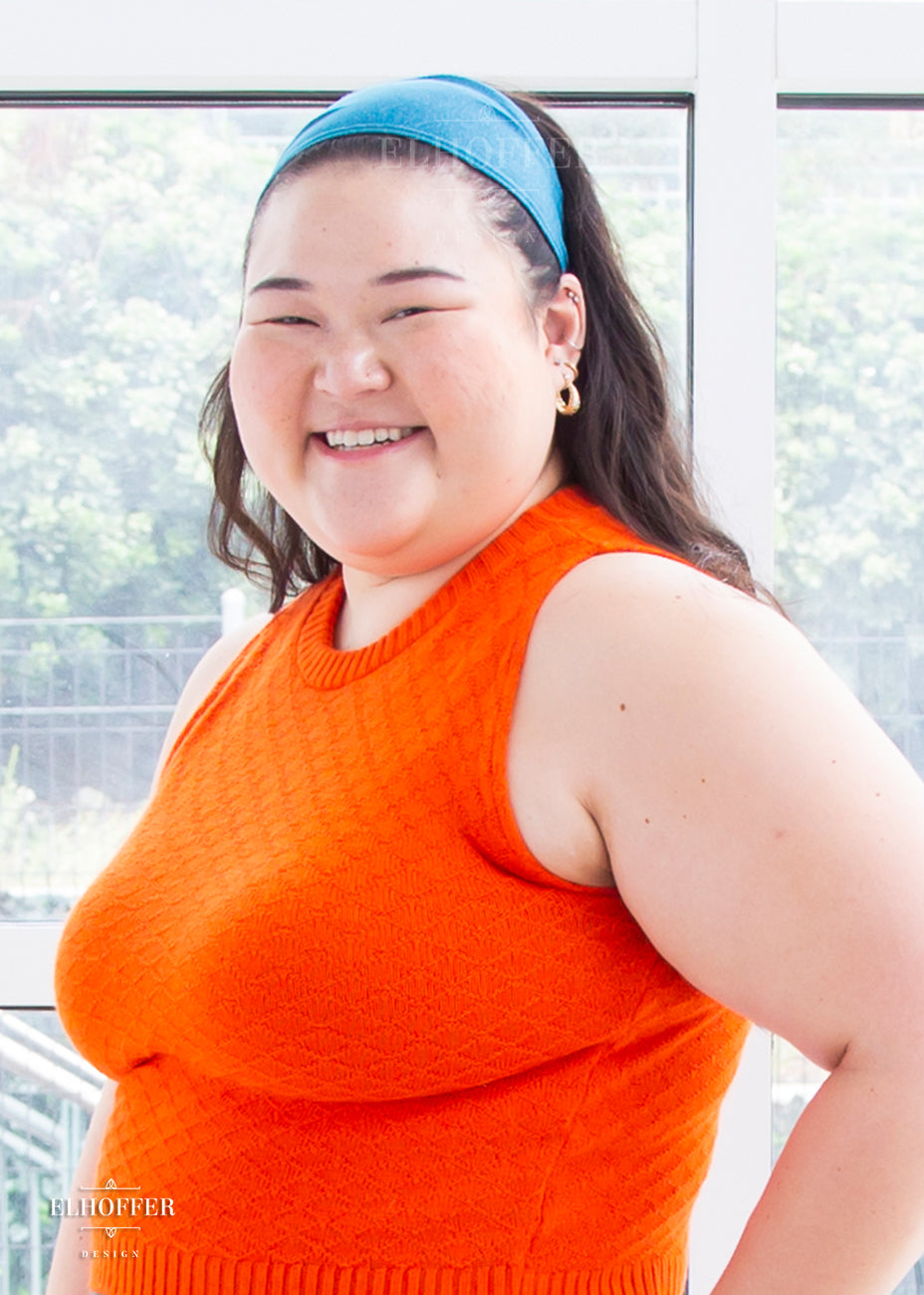 A heathered teal headband with hemmed edges. The headband is around 3" at the top and gradually gets smaller as it goes around the head.