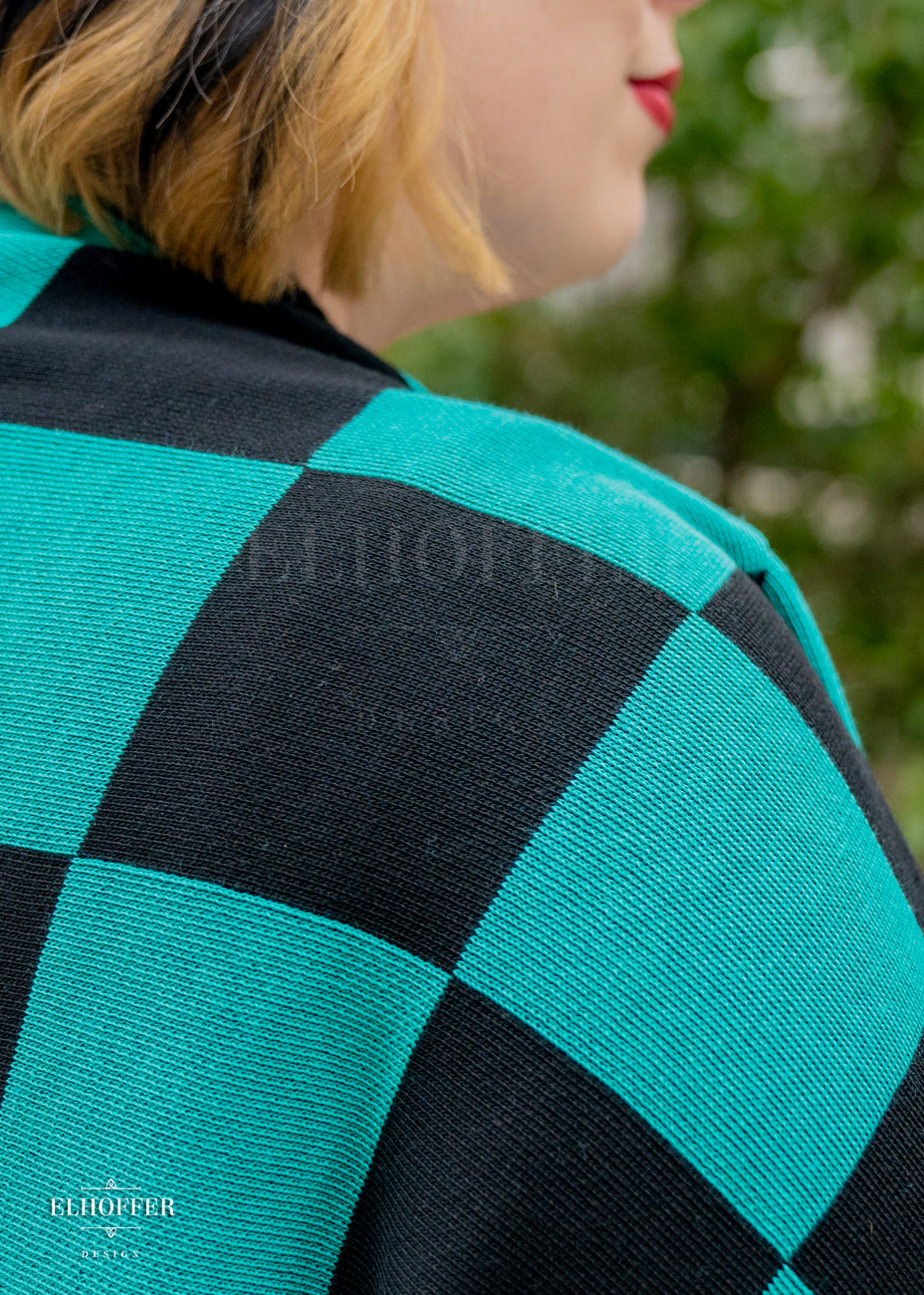 Close up of the black and green chessboard knit pattern